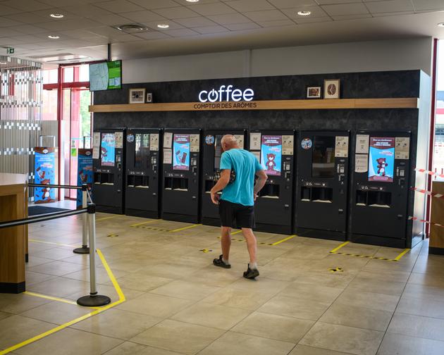 Un chauffeur routier sort des toilettes, où il s’est lavé, sur l’aire de repos Orléans-Saran. Au sol, des marquages pour faire respecter la distanciation sociale près des machines à café.