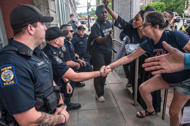 Les policiers d’Auburn, dans le Maine, ont serré la main de manifestants, un genou à terre.