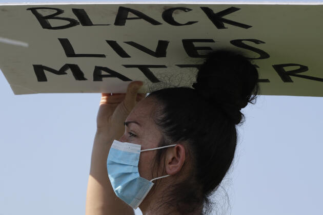 A Buffalo Grove, dans l’Illinois, une jeune femme se protégeait du soleil à l’aide d’une pancarte « Black Lives Matter ».