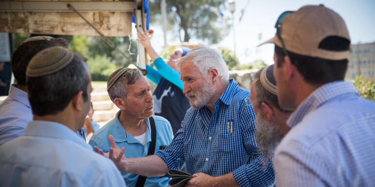 Ze'ev Chever (Zambish) speaks with heads of local authorities in Judea and Samaria at the protest tent of Beit el residents in front of the prime minister office in Jerusalem on June 18, 2017. The residents demand from prime minister Benjamin Netanyahu to build 300 apartments in Beit El as he promised five years ago. Photo by Yonatan Sindel/Flash90
