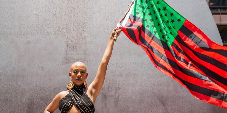 CHICAGO, ILLINOIS - JUNE 19: Performer Keya Trammell waves the Black Liberation flag during the Million Man March on June 19, 2020 in Chicago, Illinois. Juneteenth commemorates June 19, 1865, when a Union general read orders in Galveston, Texas stating all enslaved people in Texas were free according to federal law.   Natasha Moustache/Getty Images/AFP
== FOR NEWSPAPERS, INTERNET, TELCOS & TELEVISION USE ONLY ==
