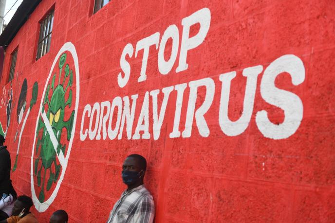 Un homme s’appuie sur le mur avec un graffiti sensibilisant au coronavirus Covid-19, à Nairobi le 6 juin.