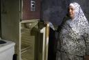 A Lebanese woman displays the content of her refrigerator at her apartment in the southern city of Sidon on June 16, 2020. Lebanon's economic crisis has led to a collapse of the local currency and purchasing power, plunging whole segments of the population into poverty as exemplified by near-empty fridges in many households. / AFP / Mahmoud ZAYYAT
