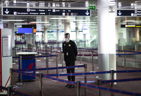 A member of Charles de Gaulle airport personnel wears a protective face mask and visor in Terminal 2 of Charles de Gaulle international airport in Roissy near Paris, on May 14, 2020, as France eases lockdown measures taken to curb the spread of the COVID-19 (the novel coronavirus). (Photo by Ian LANGSDON / EPA POOL / AFP)