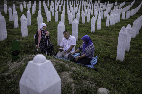 Sabahudin Mehic, accompanied by his sister and mother, leads the prayer at the grave of his father, a victim of Srebrenica genocide, at the cemetery in Potocari, near Srebrenica July 9, 2020. Photo Damir Sagolj for Le Monde