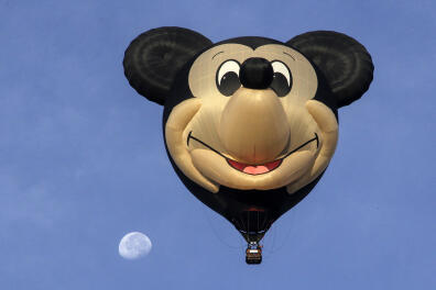 A hot-air balloon depicting Mickey Mouse and the moon are seen during the XVIII International Balloon Festival at the Metropolitan Park in Leon, Guanajuato state, Mexico on November 16, 2019. (Photo by MARIO ARMAS / AFP)