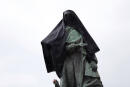 French military commander Joseph Gallieni statue is covered with a black clothe during an action held by anticolonial activists, in Paris, Thursday, June 18, 2020. Gallieni began a colonial career at the end of the 19th century and later played an important role during First World War as a military governor of Paris. Gallieni used brutal methods to quell rebellion of local populations in French colonies, including as a governor of Madagascar where he abolished the 350-year-old monarchy on the island. (AP Photo/Thibault Camus)