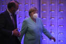 German Chancellor Angela Merkel, right, walks with MEP Manfred Weber, from Germany, as she leaves after addressing the plenary at the European Parliament in Brussels, Wednesday, July 8, 2020. Germany has just taken over the European Union's rotating presidency, and must chaperone the 27-nation bloc through a period of deep crisis for the next six months and try to limit the economic damage inflicted by the coronavirus. (AP Photo/Francisco Seco)