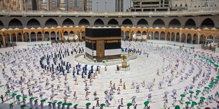 A hadnout picture released by the Saudi ministry of media shows pilgrims circumambulating around the Kaaba, Islam's holiest shrine, at the centre of the Grand Mosque in the holy city of Mecca at the start of the annual Muslim Hajj pilgrimage on July 29, 2020.  Mask-clad Muslim pilgrims began the annual hajj, dramatically downsized this year as the Saudi hosts strive to prevent a coronavirus outbreak during the five-day pilgrimage. The hajj, one of the five pillars of Islam and a must for able-bodied Muslims at least once in their lifetime, is usually one of the world's largest religious gatherings. - RESTRICTED TO EDITORIAL USE - MANDATORY CREDIT 