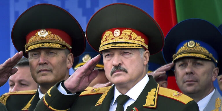 FILE In this file photo taken on Tuesday, July 3, 2018, Belarus President Alexander Lukashenko, center, attends a military parade marking Independence Day in Minsk, Belarus.  Belarus‚Äô authoritarian President Alexander  Lukashenko faces a perfect storm as he seeks a sixth term in the election held Sunday, Aug. 9, 2020 after 26 years in office. Mounting public discontent over the worsening economy and his government‚Äôs bungled handling of the coronavirus pandemic has fueled the largest opposition rallies since the Soviet collapse.  (Sergei Gapon/Pool Photo via AP, File)