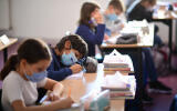 Pupils wearing protective masks write during a class at Françoise-Giroud middle school in Vincennes, east of Paris, on September 1, 2020, on the first day of the school year amid the Covid-19 epidemic. - French pupils go back to school on September 1 as schools across Europe open their doors to greet returning pupils this month, nearly six months after the coronavirus outbreak forced them to close and despite rising infection rates across the continent. (Photo by Martin BUREAU / AFP)