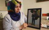 A picture taken on February 8, 2020 shows Melek Cetinkaya holding a photo of her son who has been in prison for over three years, during an interview with AFP at her home in the Turkish capital, Ankara. - Cetinkaya, whose son Furkan has been in prison for over three years, has been detained nearly 30 times and faces her first court case on March 12. After the interview with AFP, she was again detained but released shortly after. Her air force cadet son, Furkan Cetinkaya, was arrested when he was 19 years old following the July 2016 failed coup. Furkan and 115 others were jailed for life over involvement in the coup attempt but the families and cadets insist they are innocents and were told by their commanders there was a terrorist attack and they had to return to their school in Istanbul. (Photo by Adem ALTAN / AFP)