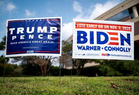 FILE PHOTO: Yard signs supporting U.S. President Donald Trump and Democratic U.S. presidential nominee and former Vice President Joe Biden are seen outside of an early voting site at the Fairfax County Government Center in Fairfax, Virginia, U.S., September 18, 2020. REUTERS/Al Drago/File Photo