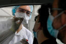 A health official collects a nasal swab sample from a man for a Covid-19 coronavirus test in a "Covid Drive" at the University Hospital Center (CHU) in Rennes, western France, on September 7, 2020. (Photo by Damien MEYER / AFP)