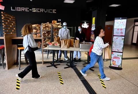 Students take packed lunches at a university restaurant in Rennes, western France on May 5, 2020, as the country is under lockdown to stop the spread of the Covid-19 pandemic caused by the novel coronavirus. (Photo by DAMIEN MEYER / AFP)