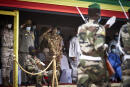 Colonel Assimi Goita (4 L), president of the CNSP (National Committee for the Salvation of the People), salutes soldiers marching while paying tribute to former Mali President General Moussa Traore at his funeral in Bamako on September 18, 2020. - Mali held a state funeral for former Mali president Moussa Traore on September 18, 2020, attended by the head of the ruling military junta and other former leaders of the Sahel state, according to AFP journalists.
Traore, who ruled Mali for 22 years before being deposed in a 1991 coup, died at age 83 in the capital Bamako on September 15, 2020. (Photo by MICHELE CATTANI / AFP)