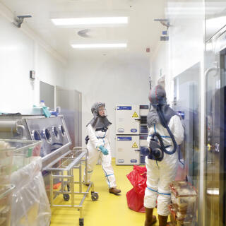 Lab technicians have to wear protective suits and carry a respirator when working with SARS-CoV2