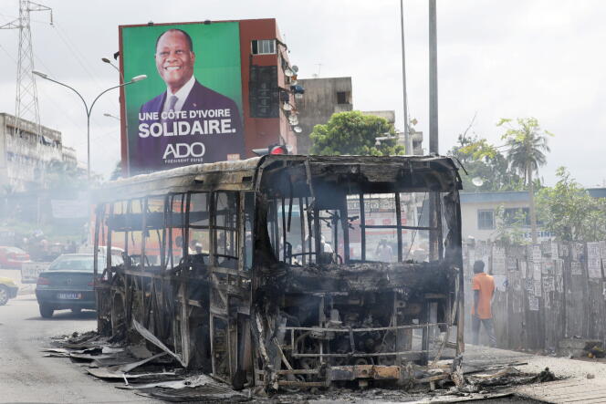 Carcasse d’un bus incendié par des manifestants qui protestaient contre la décision du président Alassane Ouattara de se présenter pour un troisième mandat, à Abidjan, le 19 octobre 2020.