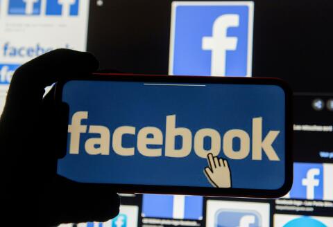FILE PHOTO: The Facebook logo is displayed on a mobile phone in this picture illustration taken December 2, 2019. REUTERS/Johanna Geron/Illustration/File Photo