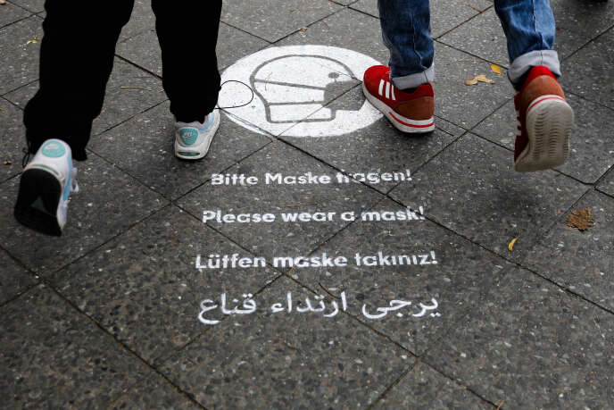 Un message demandant l'utilisation d'un masque, sur le trottoir de la Karl-Marx-Strasse dans le quartier de Neukölln, Berlin, Allemagne, 27 octobre 2020.