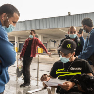 20th October, 2020. Murcia bus station. In the image, a group of Algerian migrants, who arrived in the last two weeks by boat to Cartagena, get on a bus heading to Barcelona. After having passed a period of quarantine having been in contact with a positive in COVID19, the Red Cross has provided them with a bus ticket in the direction of the destination that the migrants seek. Bottom right, Raffi, from Algeria, who aims to reach Germany.