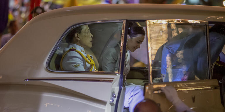 King Maha Vajiralongkorn, left and Queen Suthida, right get in to a limousine after meeting supporters in Bangkok, Thailand, Sunday, Nov. 1, 2020. Under increasing pressure from protesters demanding reforms to the monarchy, Thailand's king and queen met Sunday with thousands of adoring supporters in Bangkok, mixing with citizens in the street after attending a religious ceremony inside the Grand Palace. (AP Photo/Wason Wanichakorn)