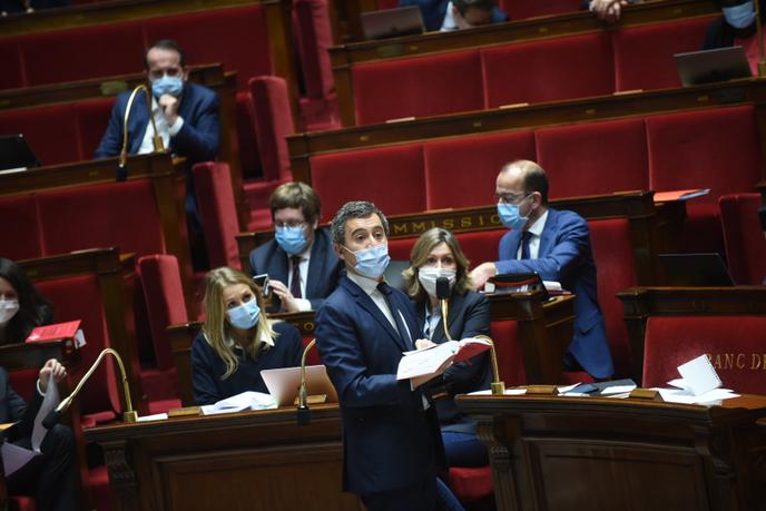 Le ministre de l’intérieur, un code civil à la main, lors du débat sur l’article 24 de la proposition de loi relative à la sécurité globale à l'Assemblée nationale, le 20 novembre.