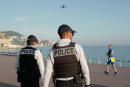 Police officers use a drone to control people on the 'Promenade des Anglais' in the French Riviera city of Nice, on March 19, 2020, on the third day of a strict lockdown in France to stop the spread of COVID-19, caused by the novel coronavirus. (Photo by VALERY HACHE / AFP)