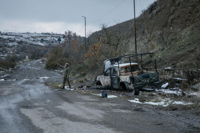 Un soldat se prend en photo devant un véhicule brûlé, à Djebrail, ville du Haut-Karabakh reprise par les Azerbaïdjanais, le 7 décembre.