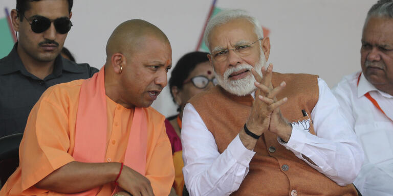 FILE- In this March 28, 2019, file photo, Indian Prime Minister Narendra Modi, right, speaks with Chief Minister of Uttar Pradesh state Yogi Adityanath during an election campaign rally in Meerut, India. India‚Äôs ruling Hindu nationalist party has approved legislation in Uttar Pradesh, the country‚Äôs most populous state, that lays out a prison term of up to 10 years for anyone found guilty of using marriage to force someone to change religion. The decree was passed Tuesday and follows a campaign by Modi‚Äôs Hindu-nationalist Bharatiya Janata Party against interfaith marriages. The party describes such marriages as ‚Äúlove jihad,‚Äù an unproven conspiracy theory used by its leaders and Hindu hard-line groups to accuse Muslim men of converting Hindu women by marriage. (AP Photo/Altaf Qadri, File)