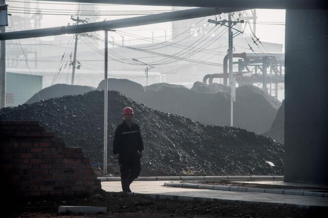 On November 9, 2015, a worker walking near the main gate of a coal-to-oil processing plant in Changzhi, Shanxi Province, China.
