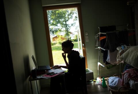 A woman works from home, on May 14, 2020 in Vertou, outside Nantes, as France eases lockdown measures taken to curb the spread of the COVID-19 pandemic, caused by the novel coronavirus. (Photo by Loic VENANCE / AFP)