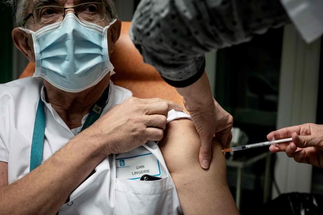 Une infirmière injecte une dose du vaccin Pfizer-BioNTech Covid-19 à un membre du personnel médical de l’hôpital de la Croix-Rousse, à Lyon, le 6 janvier.