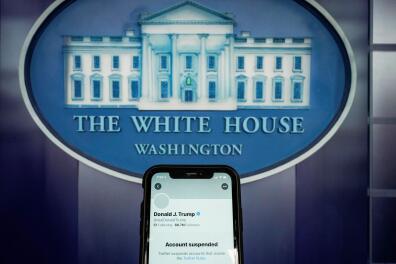 A photo illustration shows the suspended Twitter account of U.S. President Donald Trump on a smartphone at the White House briefing room in Washington, U.S., January 8, 2021. REUTERS/Joshua Roberts/Illustration