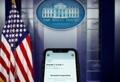 A photo illustration shows the suspended Twitter account of U.S. President Donald Trump on a smartphone at the White House briefing room in Washington, U.S., January 8, 2021. REUTERS/Joshua Roberts/Illustration