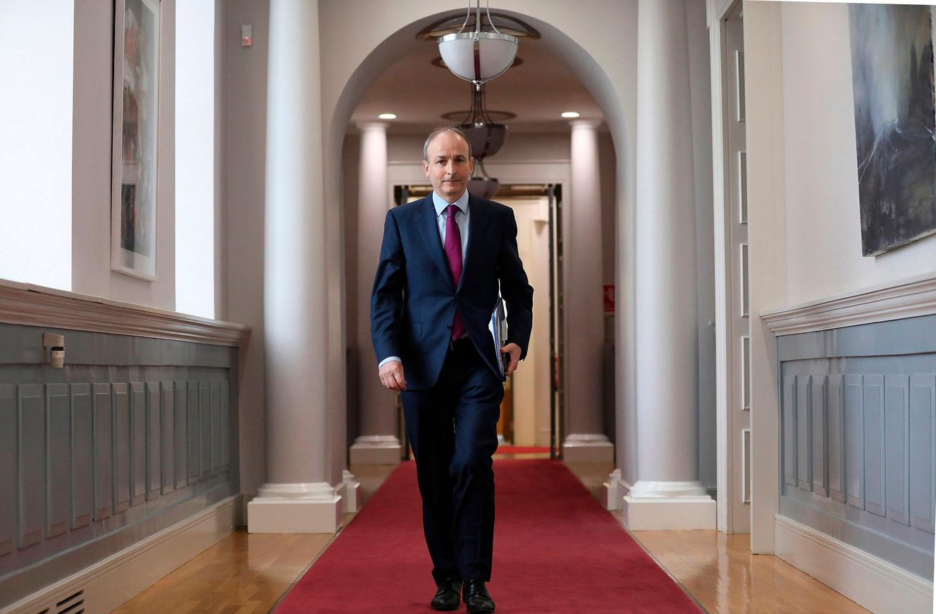 Irish Prime Minister Michelle Martin holds a copy of the Irish Commission of Inquiry report on 'Homes for Mothers and Children' in Dublin on 12 January 2021.
