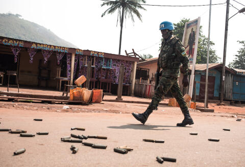 A United Nations Multidimensional Integrated Stabilization Mission in the Central African Republic (MINUSCA) soldier patrols in PK12, in front of a bar where it says "Ambiance of PK12", in front of heavy weapon casings, 12 kilometres from downtown Bangui, on January 13, 2021 where fighting raged against the rebels of the Coalition of Patriots for Change (CPC) and loyalist forces. - Rebel forces in the Central African Republic on January 13, 2021 launched two attacks close to the capital Bangui that were swiftly repelled, Central African Republic Interior Minister Henri Wanzet Linguissara said. (Photo by FLORENT VERGNES / AFP)