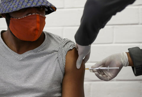 FILE PHOTO: A volunteer receives an injection from a medical worker during the country's first human clinical trial for a potential vaccine against the novel coronavirus, at Baragwanath Hospital in Soweto, South Africa, June 24, 2020. REUTERS/Siphiwe Sibeko/File Photo - RC2H2L9687DD