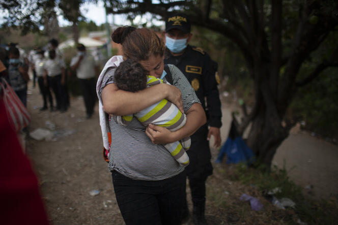 A woman and her son in the caravan of Honduran migrants on the highway in Vado Hondo, Guatemala, on January 18, 2021.