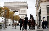 FILE PHOTO: Police officers on horses conduct a control to check exemption certificates and verify the identity on the Champs-Elysee avenue as France re-imposed a monthlong nationwide lockdown aimed at slowing the spread of the coronavirus (COVID-19), in Paris October 31, 2020. REUTERS/Benoit Tessier/File Photo