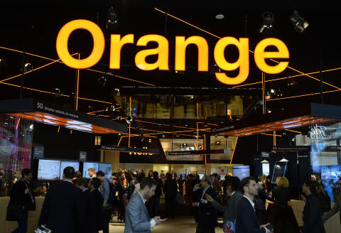 Visitors walk at the Orange stand at the Mobile World Congress (MWC) in Barcelona on February 27, 2019. - Phone makers will focus on foldable screens and the introduction of blazing fast 5G wireless networks at the world's biggest mobile fair as they try to reverse a decline in sales of smartphones. (Photo by Josep LAGO / AFP)