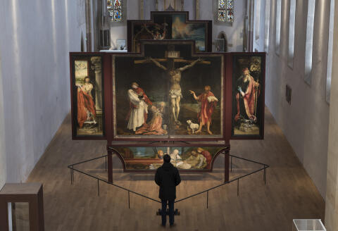 A man looks looks at the Issenheim altarpiece (retable d'Issenheim) sculpted Germans Nikolaus of Haguenau and painted by Matthias Grunewald from 1512 to 1516, before it's restoration by vanish removal at the Unterlinden museum in Colmar, northestern France, on February 7, 2019. (Photo by SEBASTIEN BOZON / AFP)