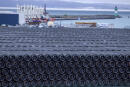 Pipes for the construction of the Nord Stream 2 natural gas pipeline from Russia to Germany and the Baltic Pipe from Denmark to Poland are stored at the port of Mukran in Sassnitz on the island of Ruegen, Germany, Wednesday, Jan. 6, 2021. Mecklenburg-Western Pomerania is apparently planning to use a state-owned foundation to secure the completion of the controversial Nord Stream 2 Baltic Sea gas pipeline from Russia to Germany. Construction of the pipeline had been halted at the end of 2019, shortly before completion, after European companies bowed to pressure from the US and withdrew pipe-laying vessels from the Baltic Sea. (Jens Buettner/dpa via AP)