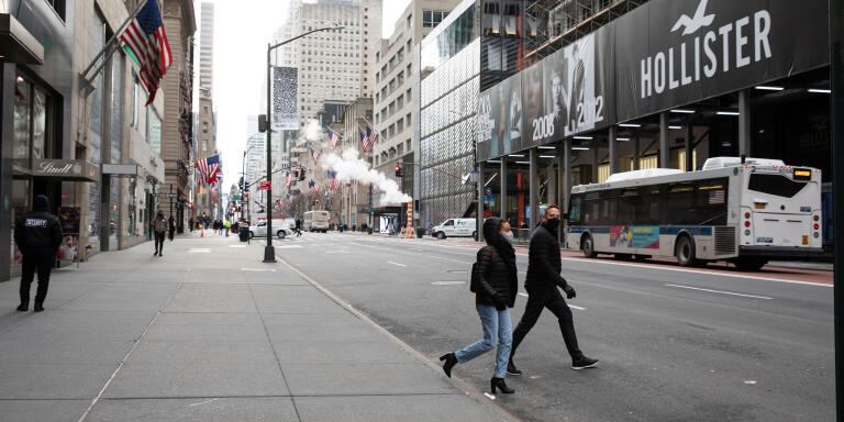 People walk along 5th Avenue on a cold winter's day in NY, NY.