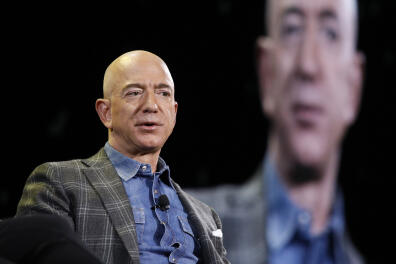 FILE - In this June 6, 2019, file photo Amazon CEO Jeff Bezos speaks at the the Amazon re:MARS convention in Las Vegas. Washington state's richest residents, including Bezos and Bill Gates, would pay a wealth tax on certain financial assets worth more than $1 billion under a proposed bill whose sponsor says she is seeking a fair and equitable tax code. Under the bill, starting Jan. 1, 2022, for taxes due in 2023, a 1% tax would be levied on "extraordinary" assets ranging from cash, publicly traded options, futures contracts, and stocks and bonds. (AP Photo/John Locher, File)