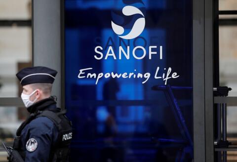 FILE PHOTO: A French policeman stands in front of the Sanofi headquarters during a protest by Sanofi's workers against job cuts in Paris as part of a national day of strikes and protests against layoffs and government's economic and social policies amid the coronavirus disease (COVID-19) outbreak in France, France, February 4, 2021. REUTERS/Benoit Tessier/File Photo