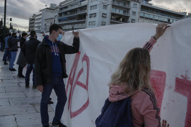 In front of the Parliament in Athens, students hold a banner against the reform creating a campus police patrol, February 11, 2021.