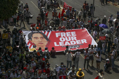 Demonstrators display a banner with an image of deposed Myanmar leader Aung San Suu Kyi during a protest against the military coup in Yangon, Myanmar, Wednesday, Feb. 17, 2021. The U.N. expert on human rights in Myanmar warned of the prospect for major violence as demonstrators gather again Wednesday to protest the military's seizure of power. (AP Photo)
