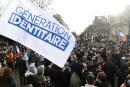 Members and supporters of far right group Generation Identitaire (GI) hold a flags during a protest against its potential dissolution in Paris on February 20, 2021. The dissolution of Generation identitaire was evoked for the first time on January 26, 2021 by Interior Minister, as a reaction to the group's recent anti-migrant operation in the Pyrenees, which led to a preliminary investigation for provocation to racial hatred. / AFP / Bertrand GUAY 