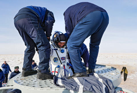 Ground personnel help Luca Parmitano of the European Space Agency to get out of the Soyuz MS-13 capsule shortly after landing in a remote area outside the town of Dzhezkazgan (Zhezkazgan), Kazakhstan, on February 6, 2020. - NASA's Christina Koch returned to Earth safely Thursday having shattered the spaceflight record for female astronauts after almost a year aboard the International Space Station. Koch touched down at 0912 GMT on the Kazakh steppe after 328 days in space along with Luca Parmitano of the European Space Agency and Alexander Skvortsov of the Russian space agency. (Photo by Sergei ILNITSKY / POOL / AFP)